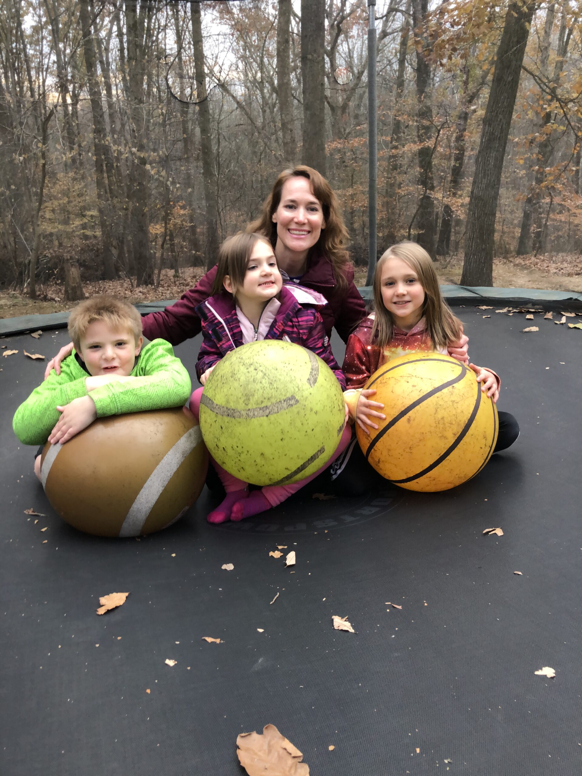 Christy Brunke on the trampoline with her daughters