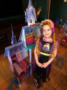Five-year-old girl with Anna costume and Frozen castle