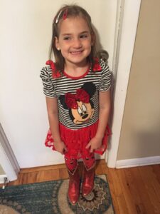 Five-year-old girl in Minnie Mouse outfit with boots
